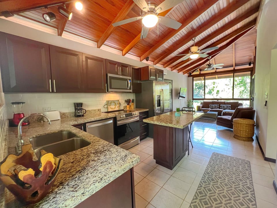 The kitchen has full-size, stainless steel appliances including a 5-burner stove and dishwasher.