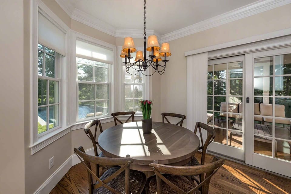 Bay Window Dining Nook Looks Out At Pool Area & Opens To Screened Porch