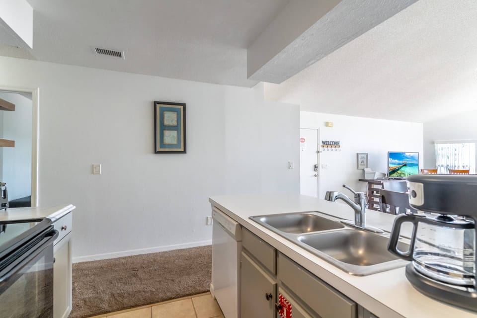 Fully equipped kitchen with electric stove and oven, drip coffee maker, refrigerator, microwave, dishwasher and more!