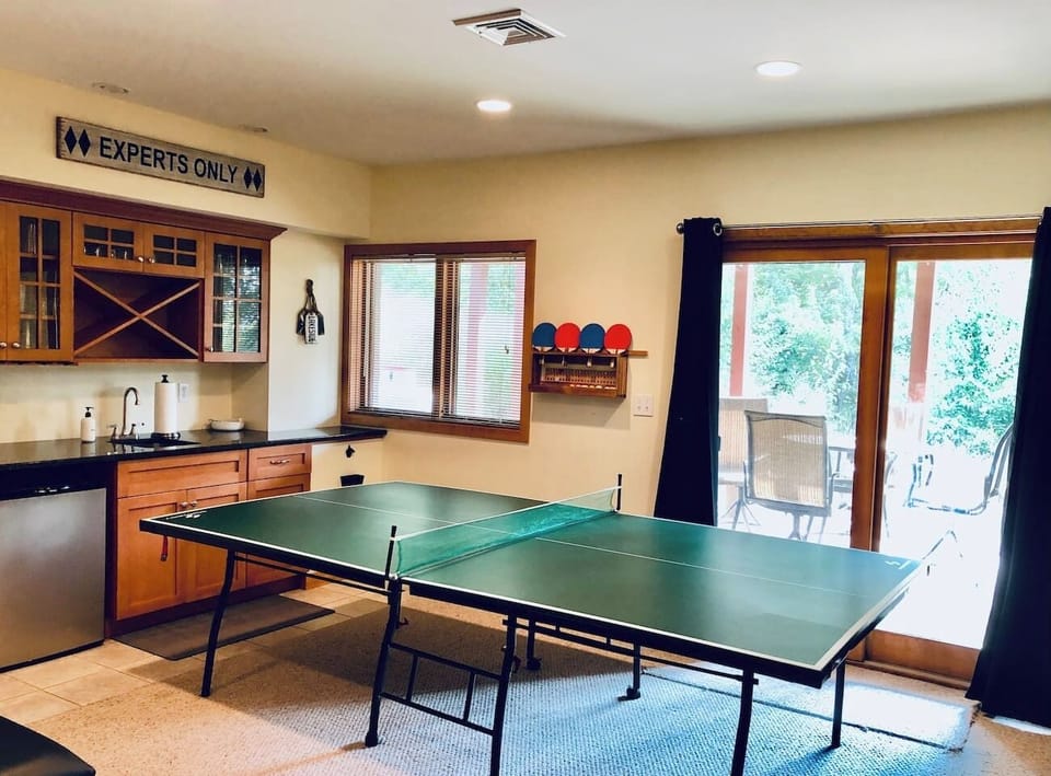 House 1 • Downstairs • Game Room • 65" Roku TV • Hulu Live TV • Large DVD Selection • Ping Pong Table • Knock Hockey • Wet Bar