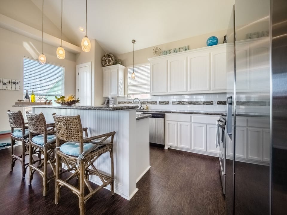 Open concept kitchen including granite, stainless, dining & bar seating 