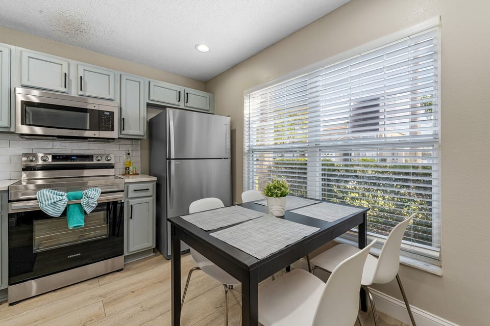 Dining nook beside the kitchen w/ natural light and relaxed seating.