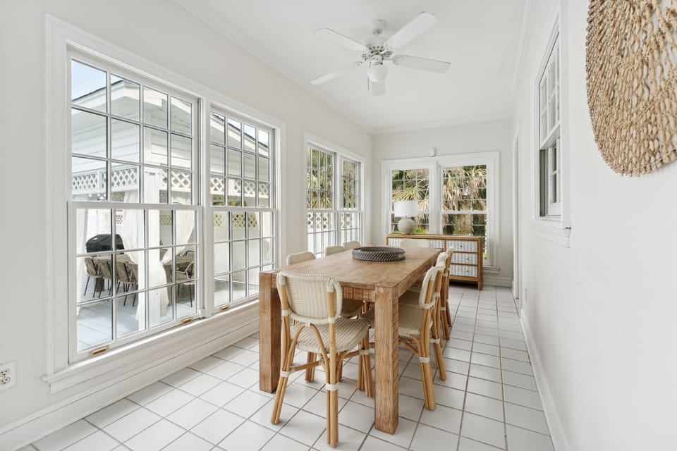 Another large table, sits 8, in the sunroom overlooking the pool