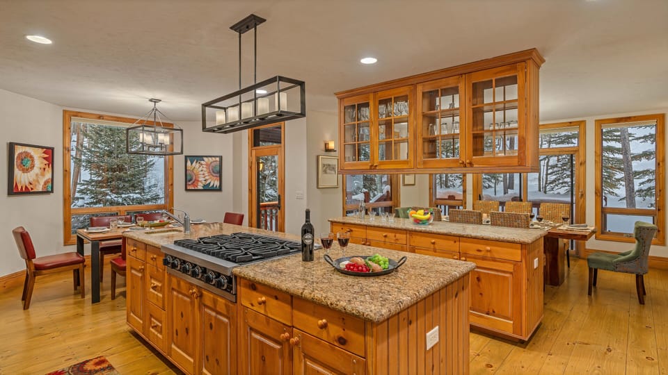 Kitchen leading into dining area, breakfast nook, and deck access