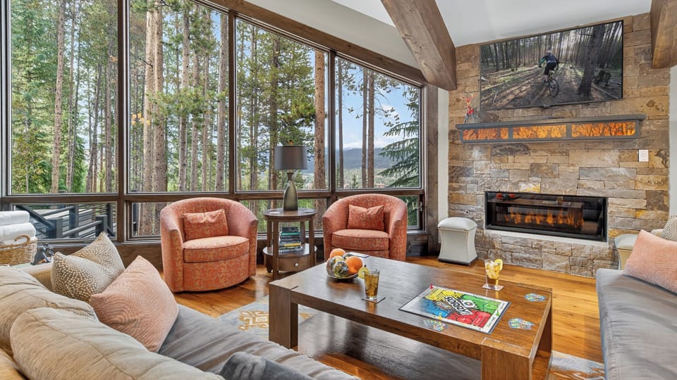 Living area with fireplace and wooded views