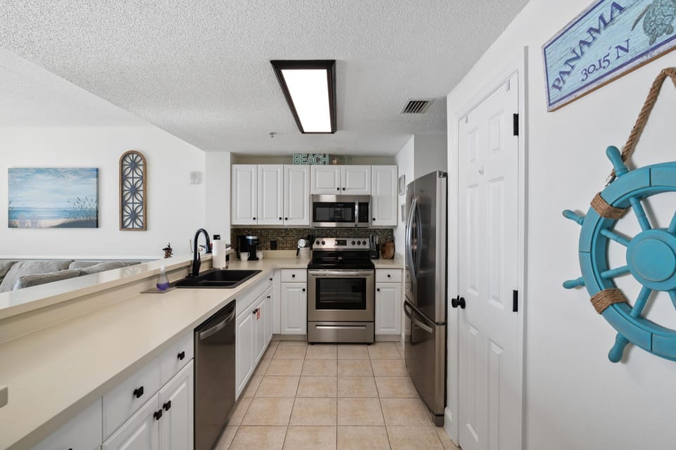 The fully equipped kitchen features quartz countertops, stainless-steel appliances, and has everything you need to prepare meals for family & friends.