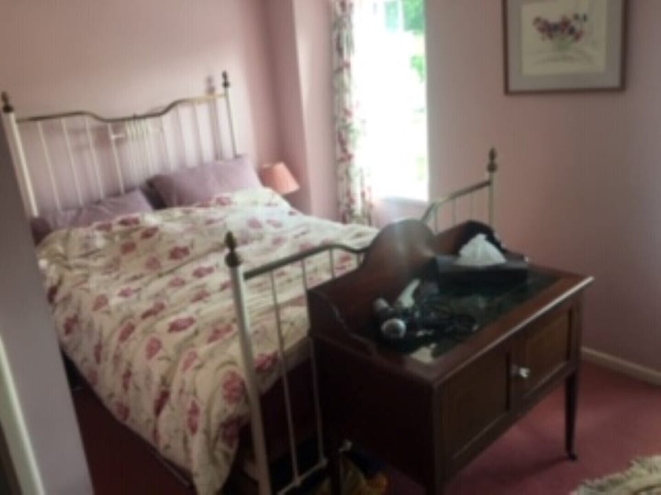 Double bedroom with antique Victorian bedstead,  wardrobes and dressing table
