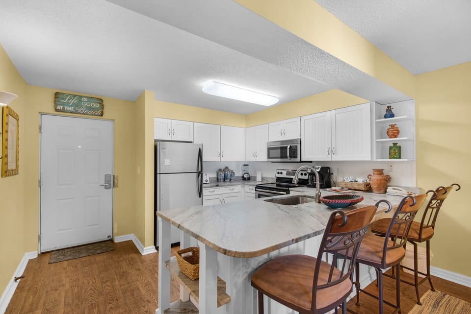 The front door looking from den.
Three stools facing the counter height bar.  