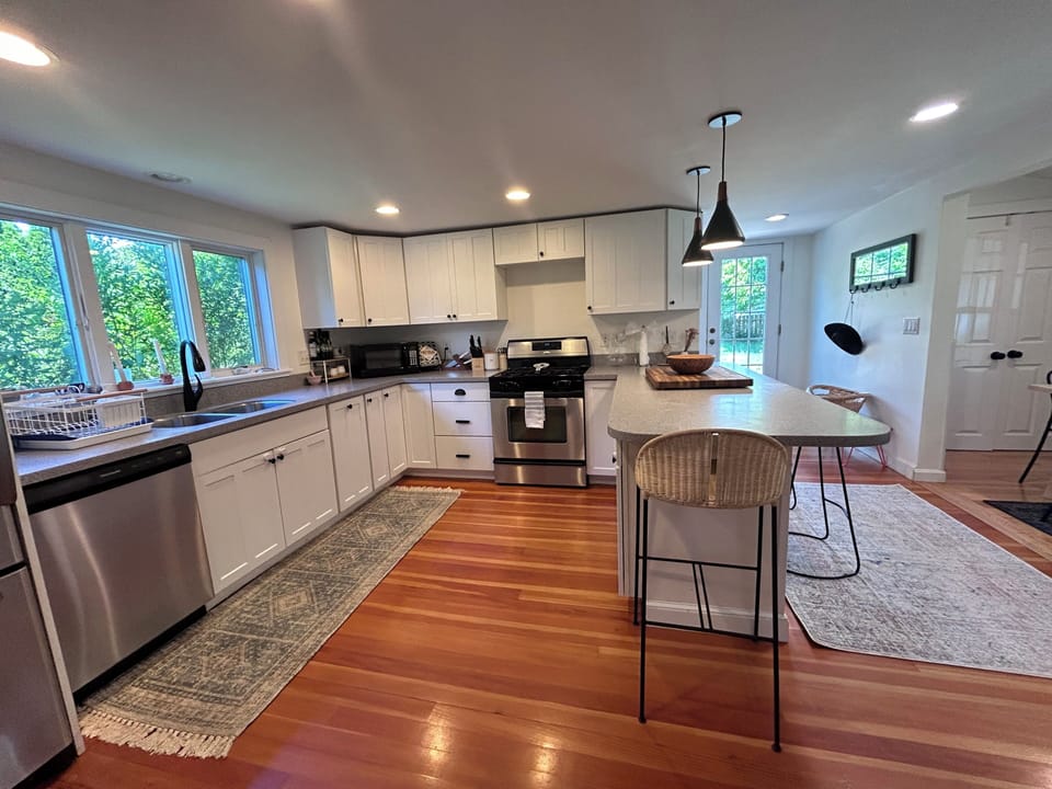 Fully equipped kitchen with breakfast bar and dining area adjacent