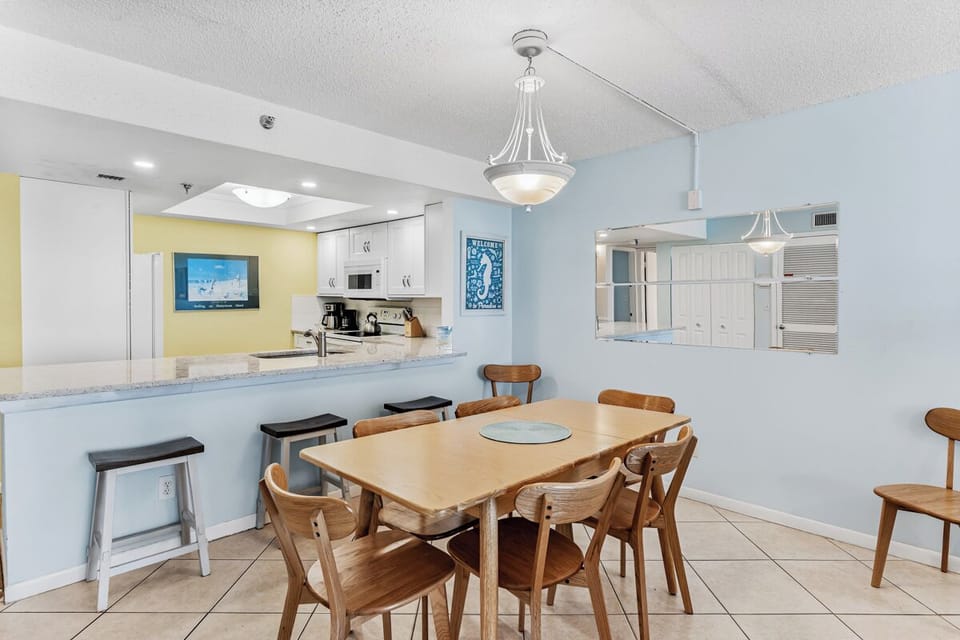Gather around this bright dining space with seating for six. The open kitchen and light-filled layout invite you to share meals and make memories together in comfort.