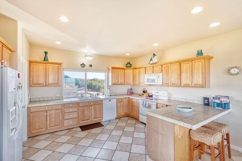 Open and well-lit allows for multiple hands in the kitchen. Features instant hot water tap.