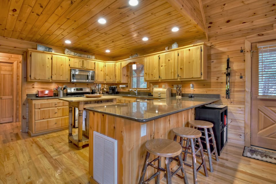View of the oversized fully stocked kitchen with breakfast bar and prep island.