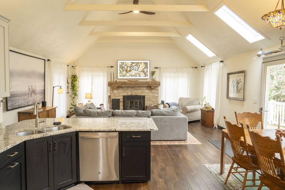 View from kitchen into living room with fireplace and Samsung Frame 65'' TV. 