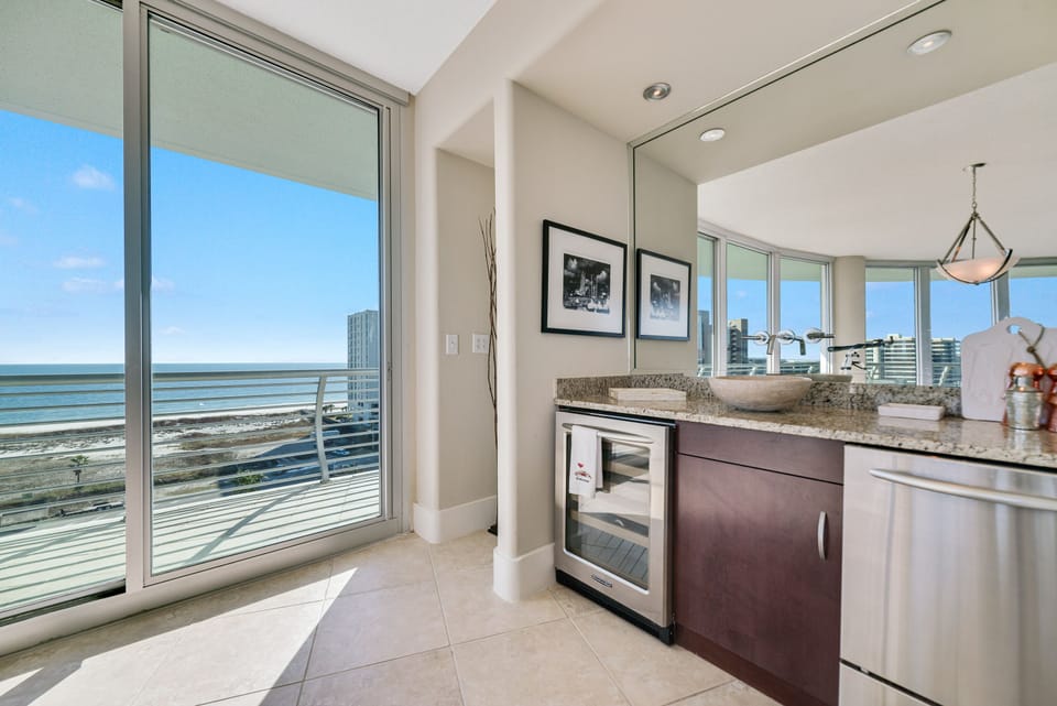 Enjoy effortless entertaining with this well-appointed dining area and wet bar. The integrated wine cooler and blender provide added convenience, while the contemporary design enhances the overall aesthetic.