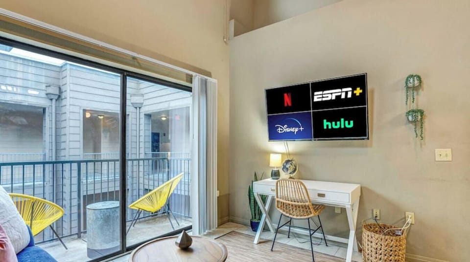 Living area with smart tv and work desk.