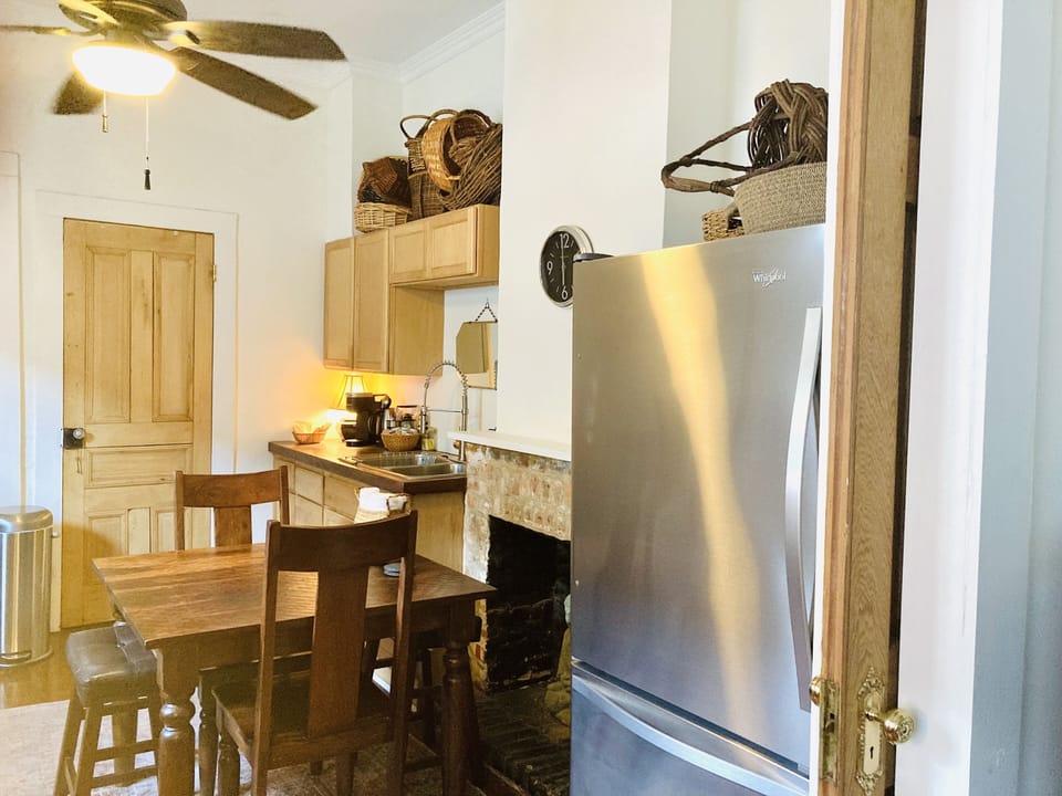 Large stainless steel appliances. A table for dining or working.