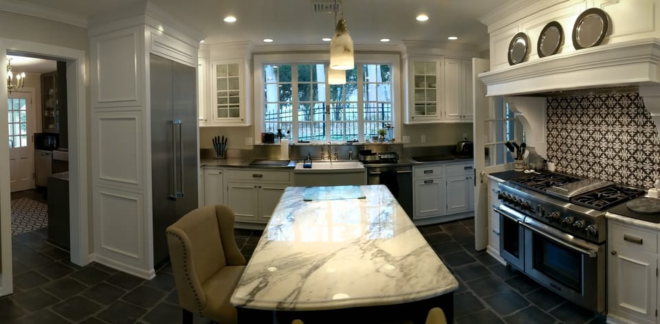 Marble island, thermador appliances and view of birds feeding under the pines. 