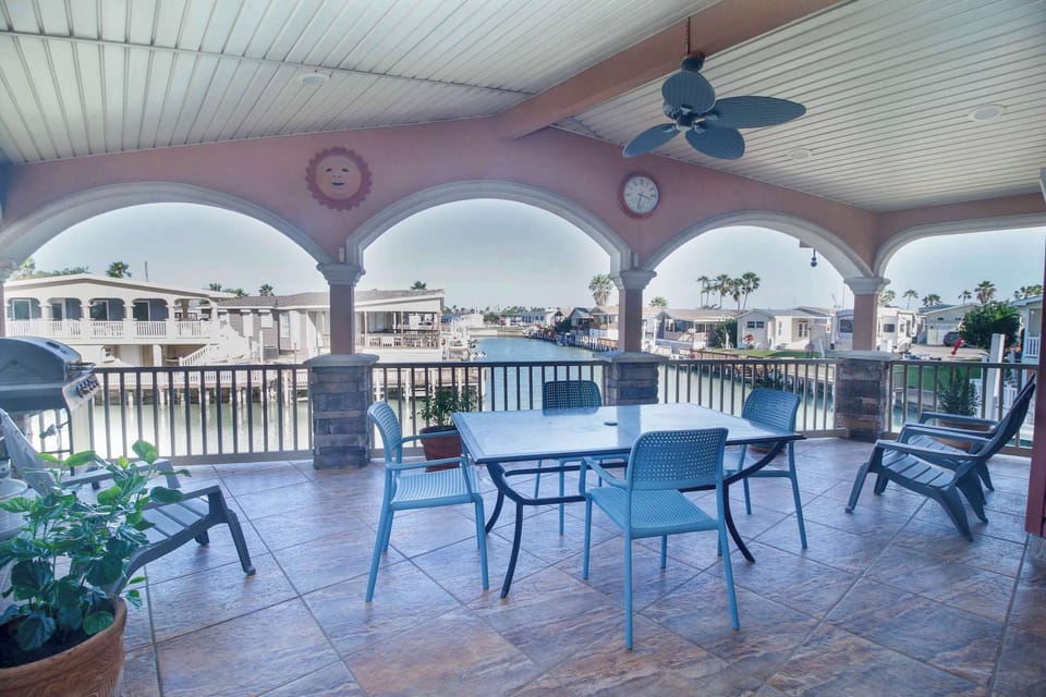 Gather on the covered deck with the canal stretching out in front of you