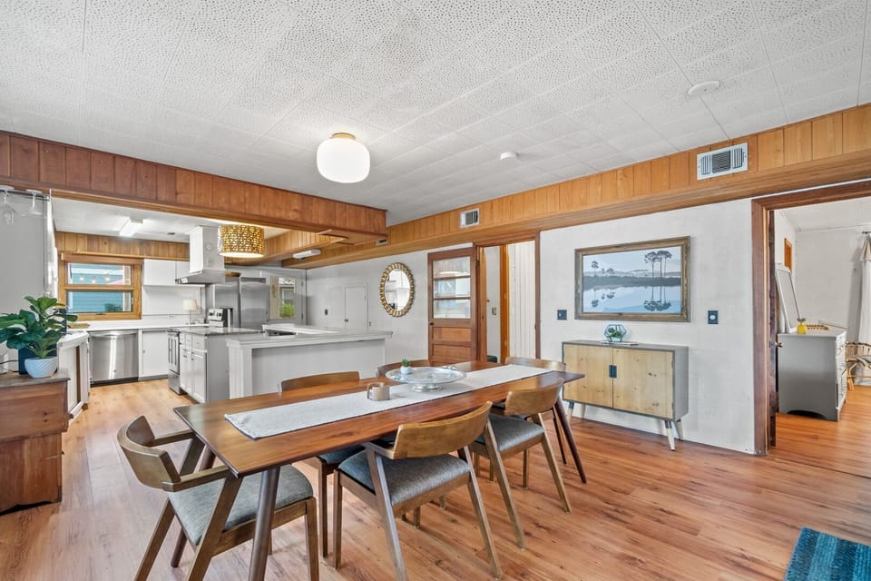 Dining room table seats 6 in large open concept living space.