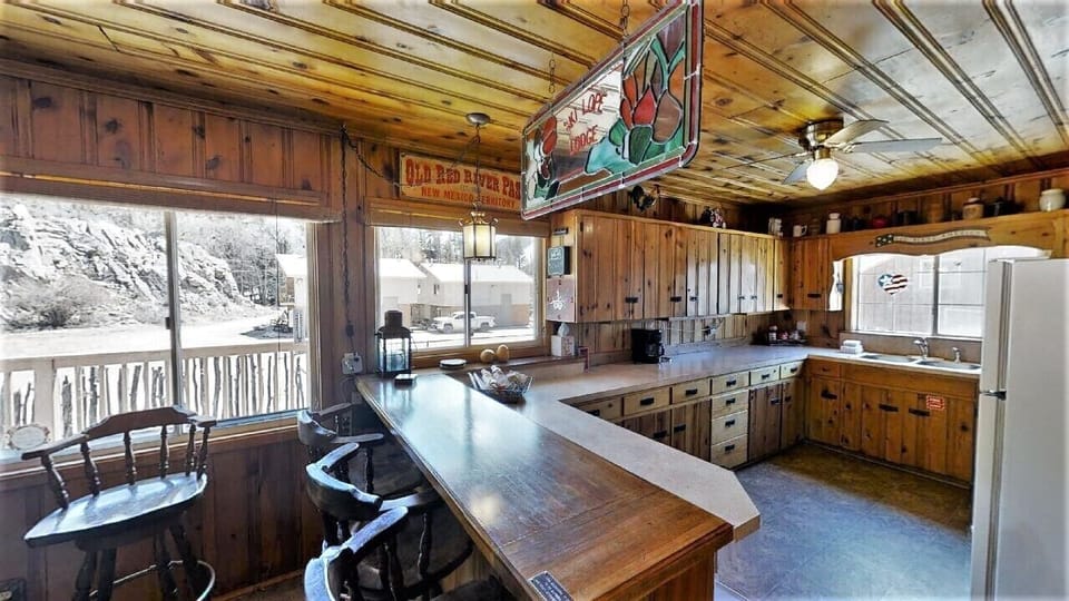 This warm wooden kitchen invites you to gather and create memories, with rustic charm and mountain views framing your culinary adventures in a space full of character.
