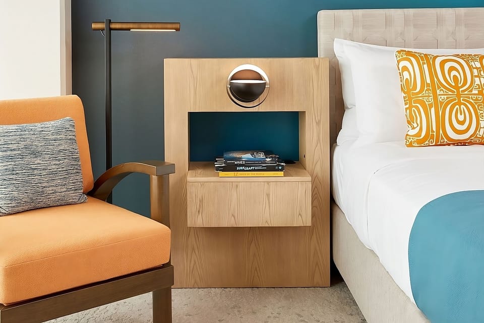 Settle into the reading chair beside warm, ambient lighting.