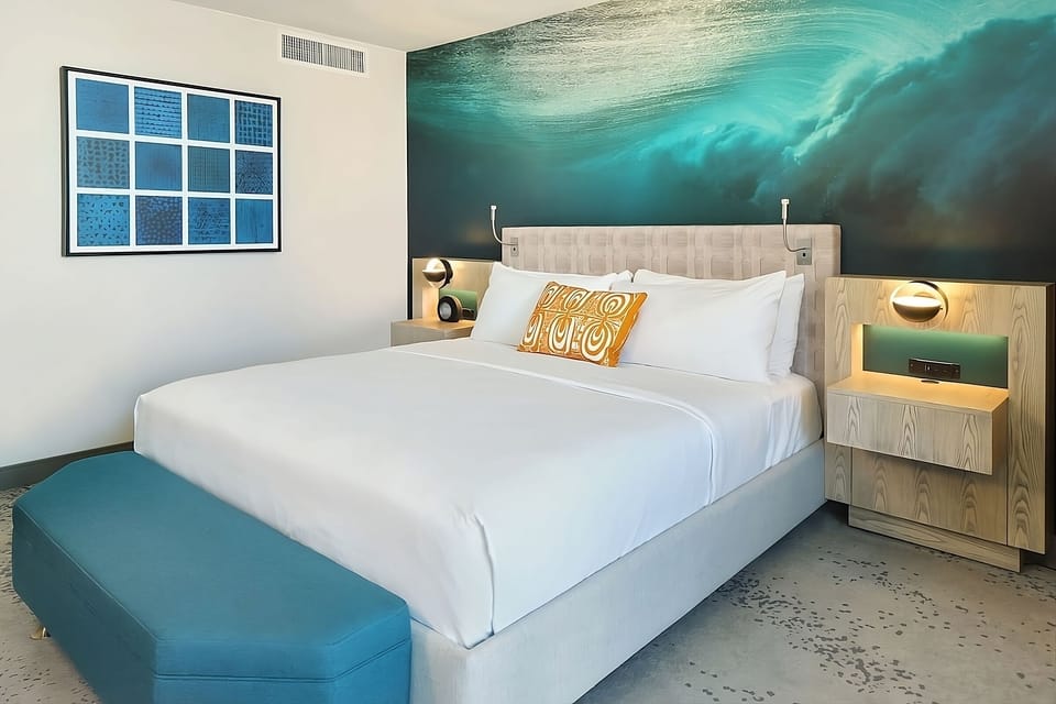 Stretch out on a plush bed framed by ocean hues.