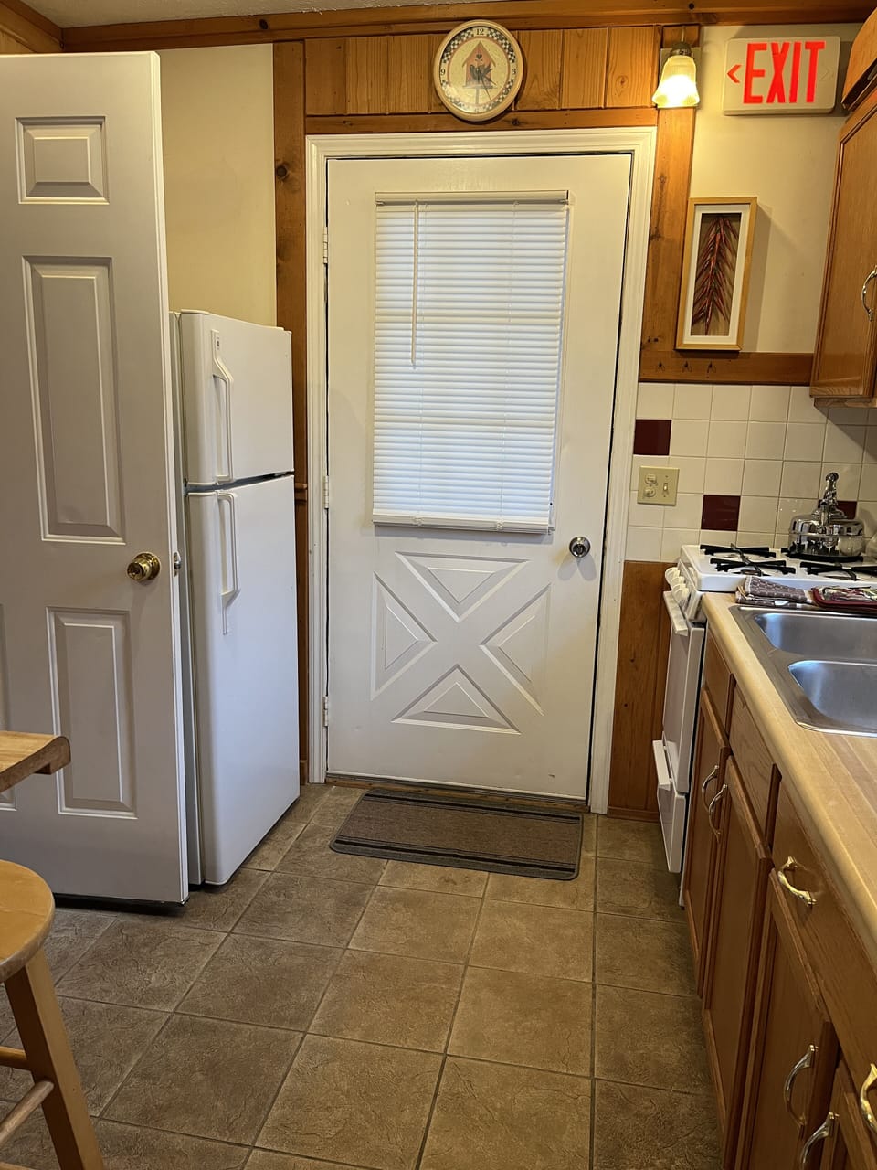 Second floor entryway, upstairs kitchen & balcony door.