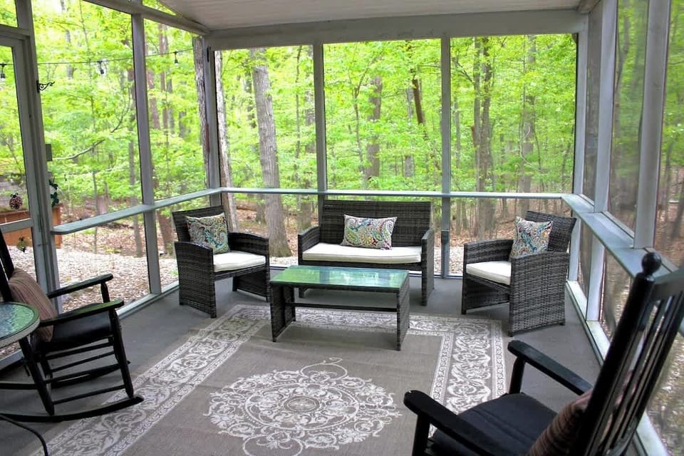 Screened in porch with plenty of seating.