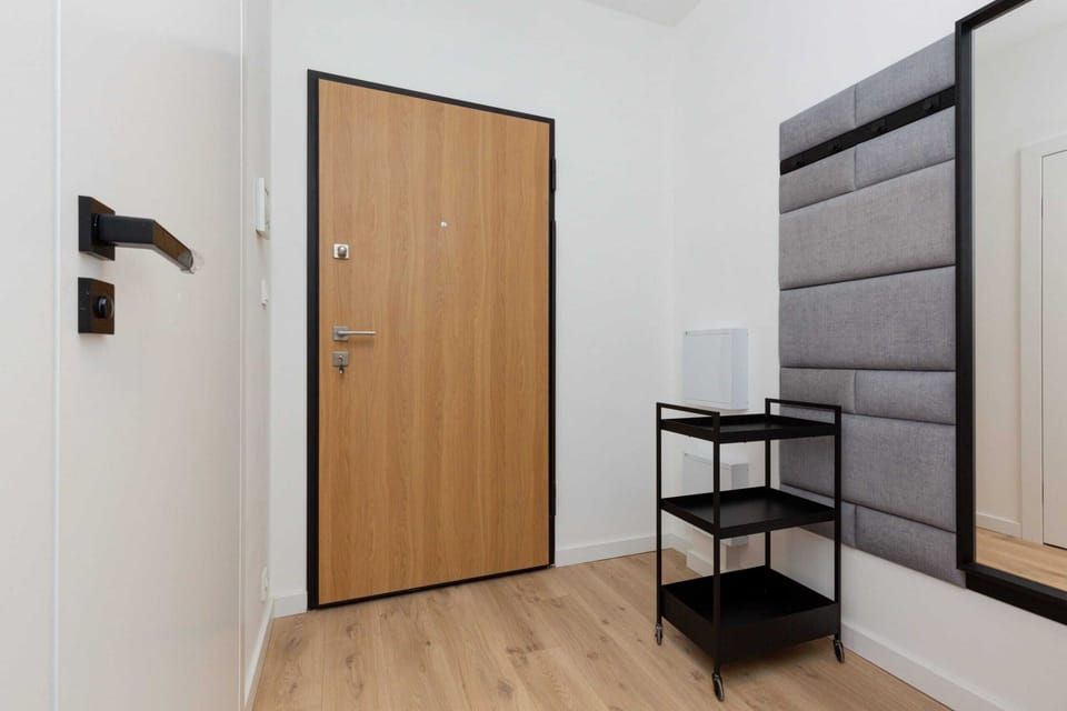 Bright and spacious hallway with wooden doors.