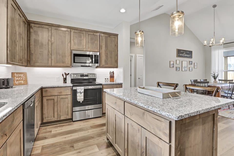 Kitchen with stove, oven, refrigerator, microwave, and coffee maker