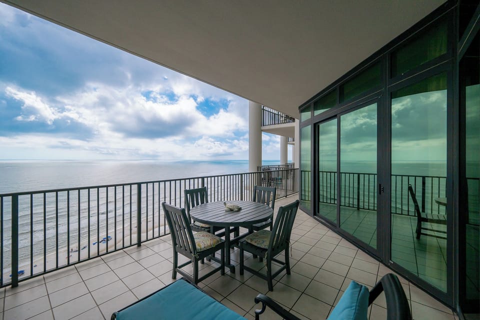 Enjoy stunning views from the spacious balcony, featuring a round dining table and comfortable seating for relaxation