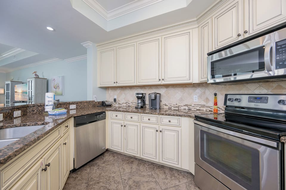 Kitchen featuring stainless appliances, granite countertops, and stylish cabinetry for a delightful cooking experience