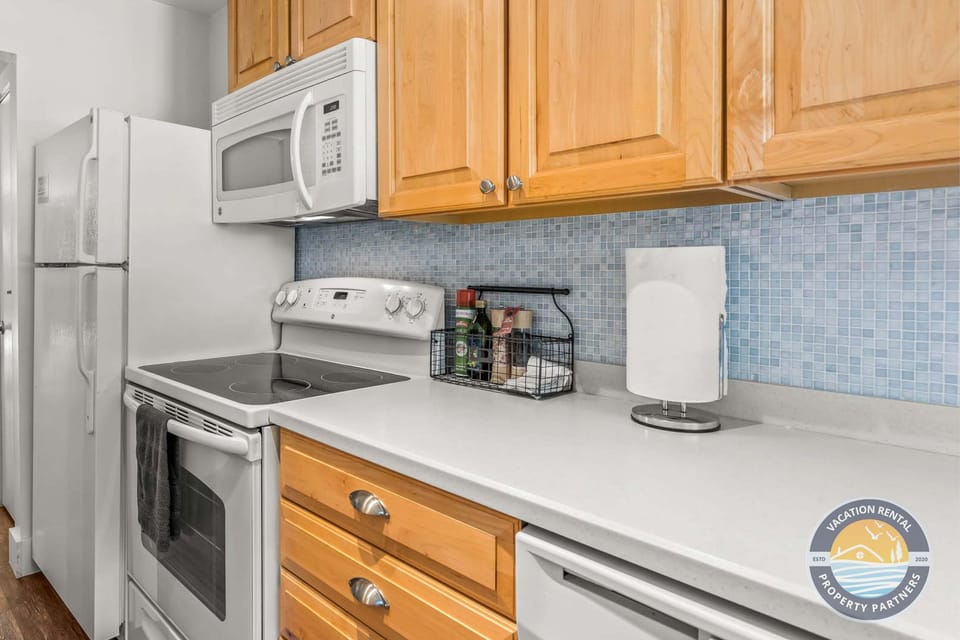 The kitchen comes stocked with essentials and convenient counter space to make meal prep simple. Everything you need for snacks, coffee, or full home-cooked meals is right at your fingertips.