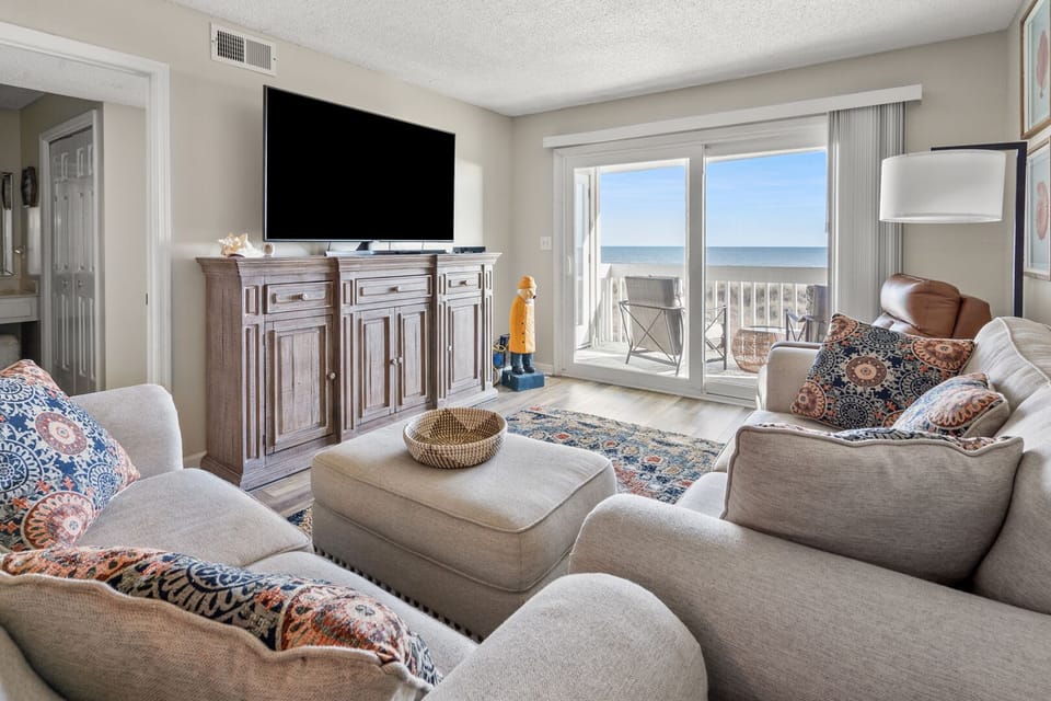 Sliding doors and coastal decor in the living area at Coastal Shores C2, a 2-bedroom Ocean Drive rental