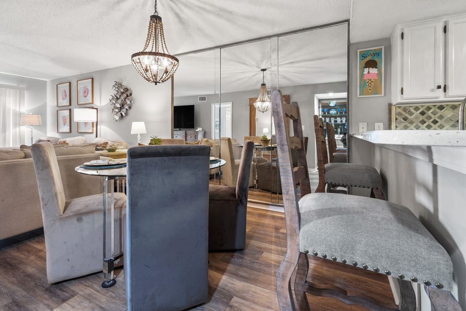 Dining seating with bar stools and a chandelier at Coastal Shores C2 on Ocean Drive