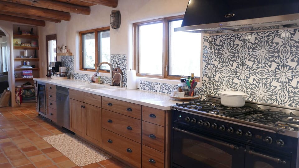 6-burner Italian gas range/griddle and rotisserie. Custom Conejo backsplash.