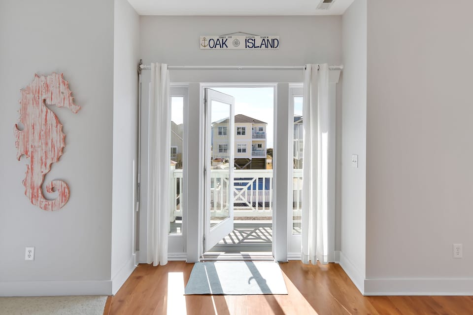 Upper level door to front deck, overlooking Atlantic Ocean from 3rd row.