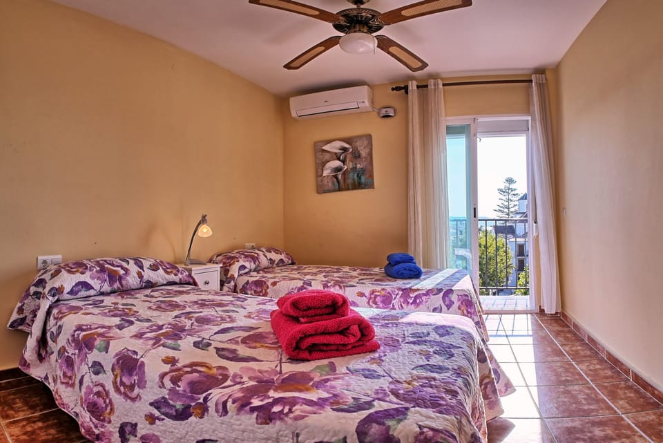 Bedroom 1 with twin beds, balcony and views over the square