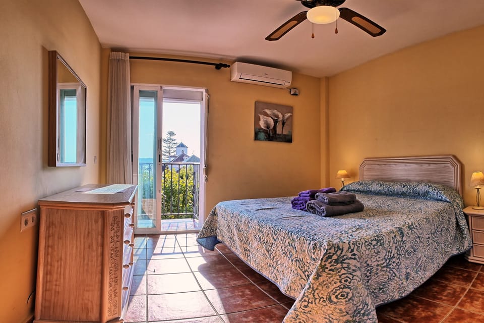 Bedroom 3 with double bed, balcony and views over the square