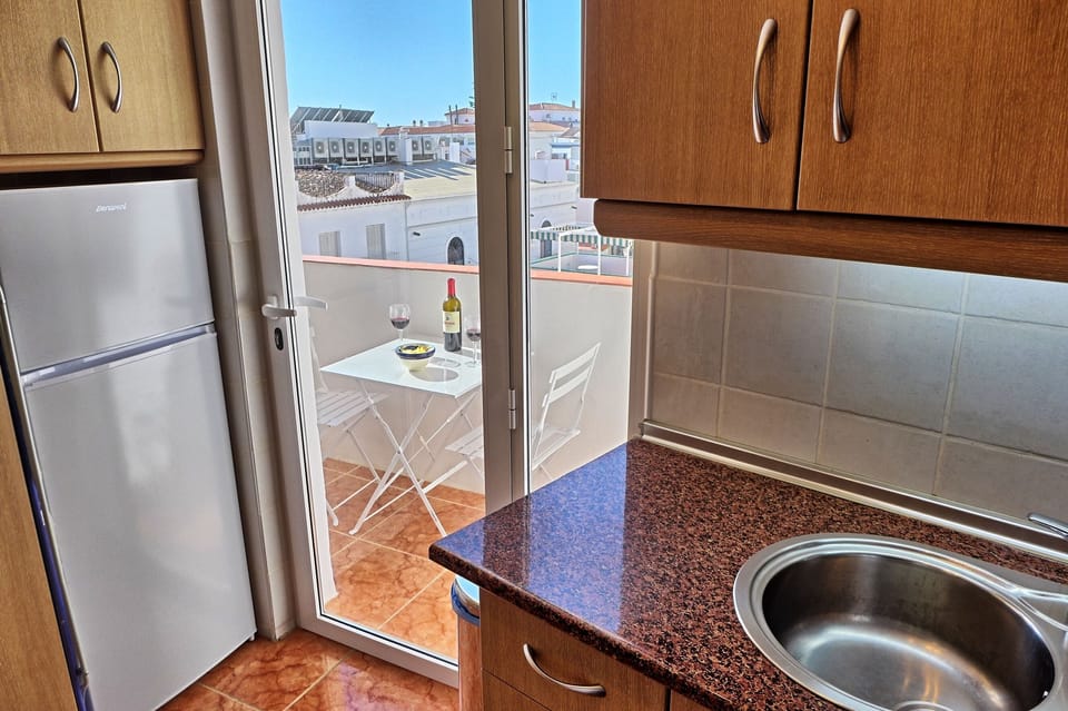 Kitchen with door opening onto west facing terrace