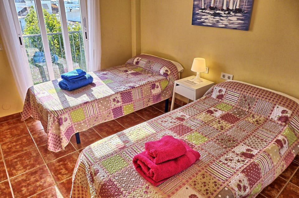 Bedroom 2 with twin beds and views over the square
