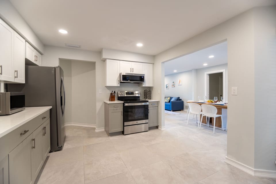 Modern open-concept kitchen leading to dining area. Perfect for entertaining!