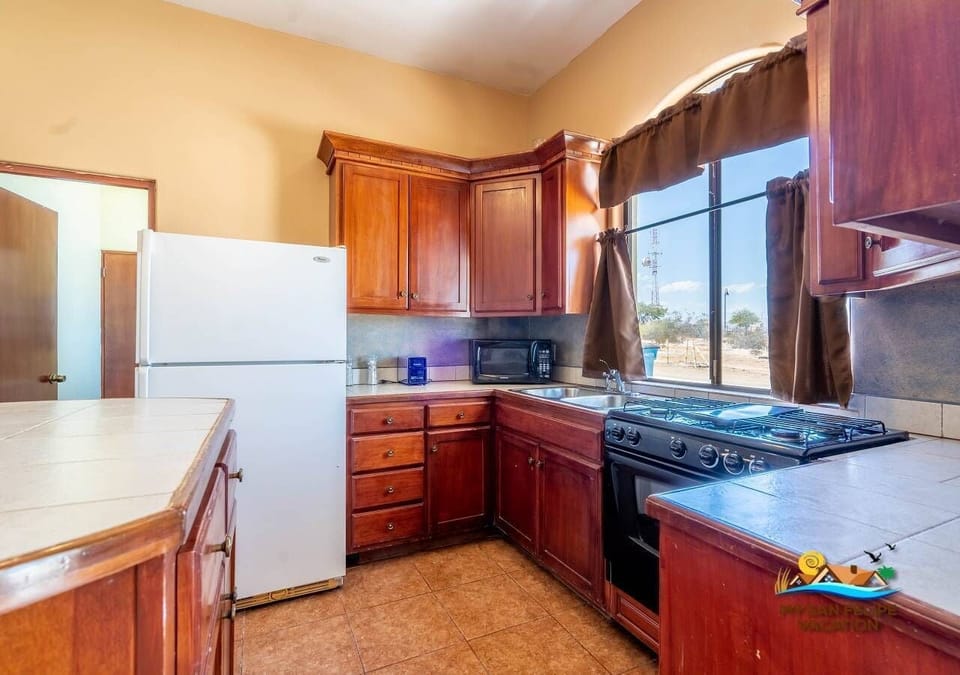 Casa Tapia features a fully equipped kitchen with a full-size refrigerator, dishwasher, microwave, oven, and stove. Perfect for preparing meals during your stay