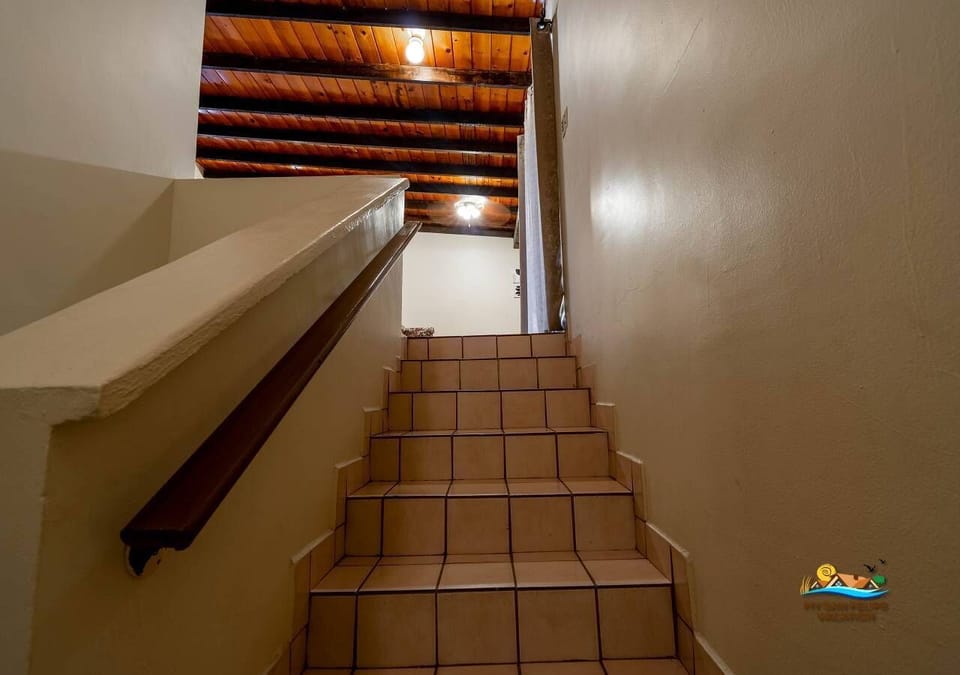 These steps lead to the upstairs living area and primary bedrooms, making it easy to move between levels without walking through the main room.