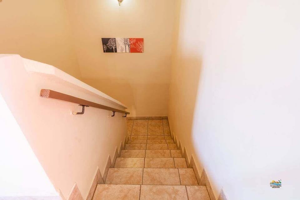 These interior stairs lead to the upstairs kitchen, living room, and additional bedrooms. Located just steps from the sand .