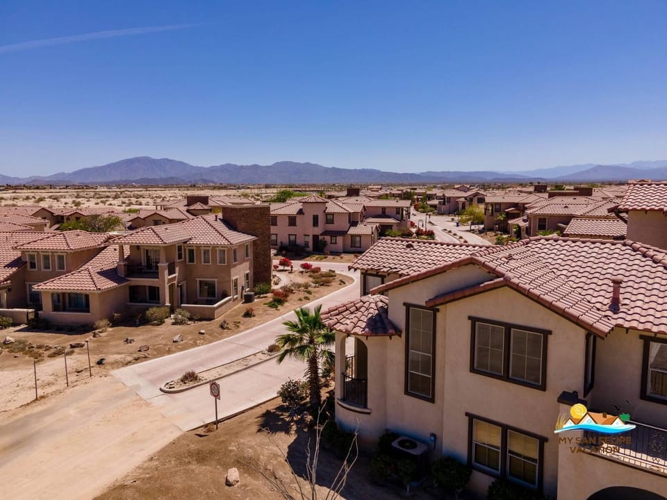 Aerial view of Villa 433 within the gated community — golf course, pools, and beach access visible .