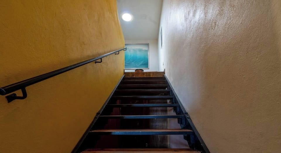 Elegant interior staircase at Casa Las Palmas in the Las Palmas community of San Felipe BC MX — connecting living areas to upper-level bedrooms.