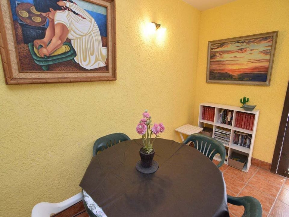 Glass dining table with seating for four — located between the living room and kitchen, perfect for group meals.