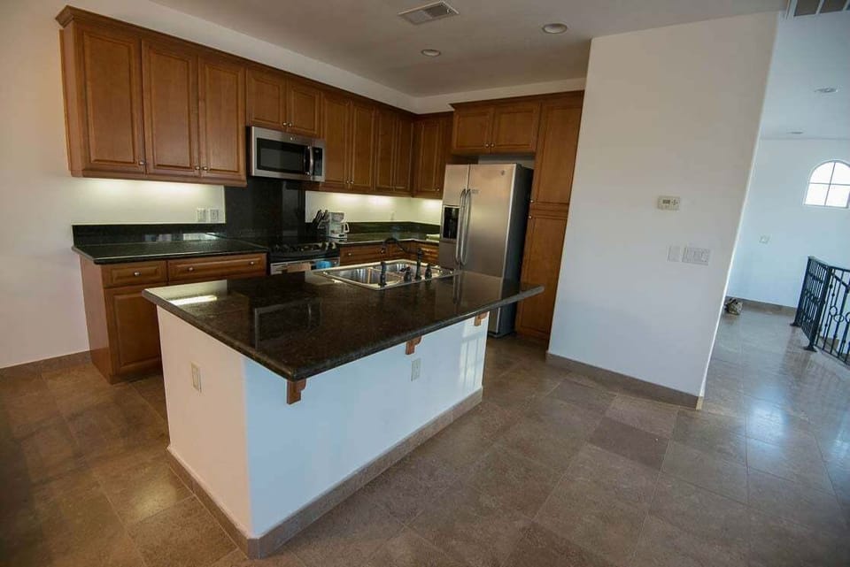 This San Felipe vacation rental features a full kitchen with modern appliances, including a refrigerator, stove, microwave, and dishwasher — plus essential cookware and dining ware for home-cooked meals.