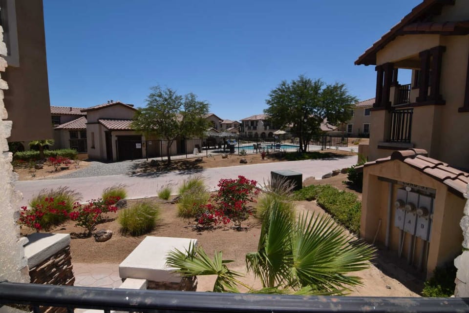 From the front entrance, you can see the community pool just steps away — with the pool visible through sliding glass doors in the living area.


Next